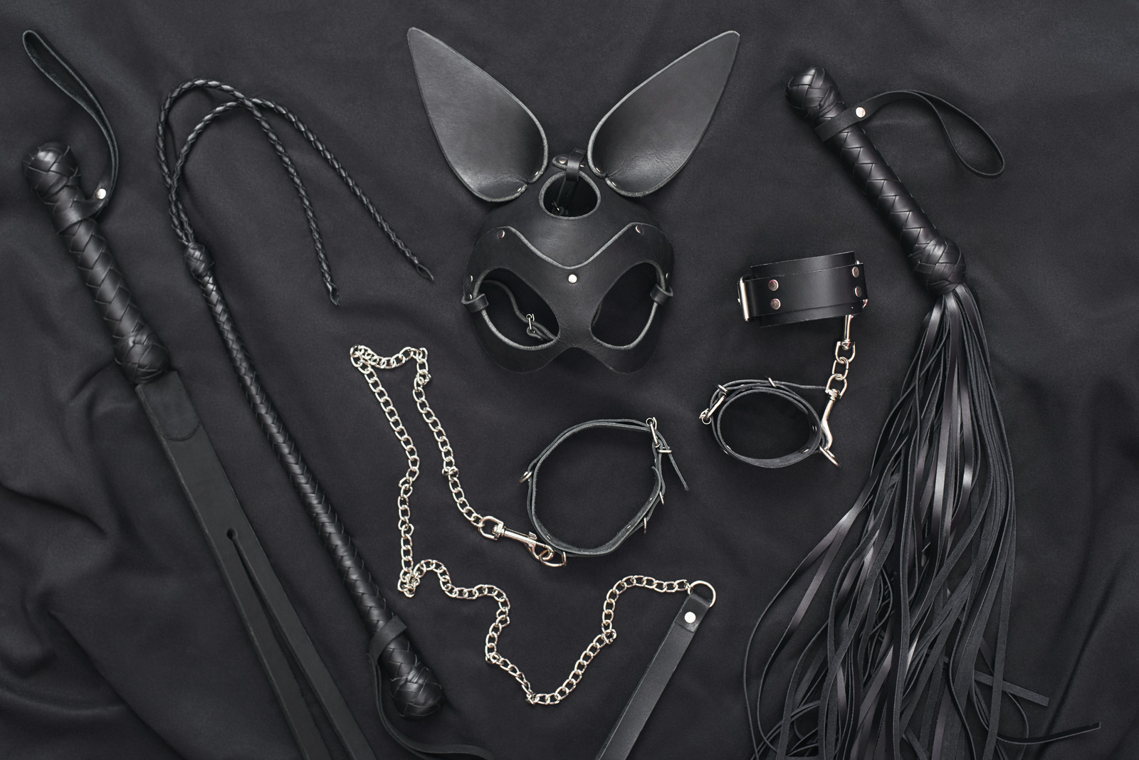 Explore The World Of Kinky Play Top View Of Bdsm Leather Kit Whips Handcuffs Mask And Chain